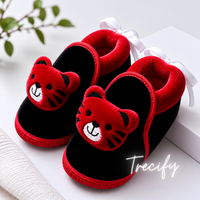 Red and black slippers with teddy bear faces on a white surface, branded 'Trecify'.